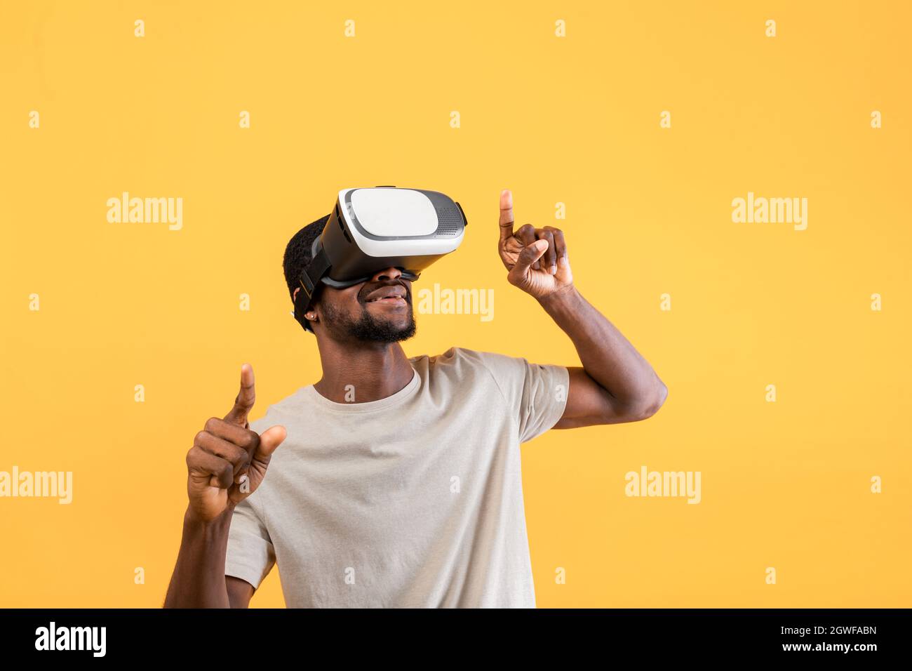 African american guy in modern VR glasses exploring virtual reality ...