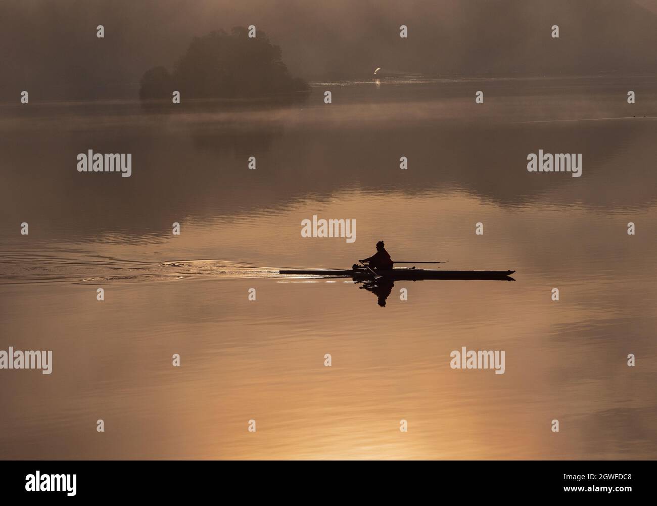 Silhouette In Woman On Boat In Lake During Sunset Stock Photo - Alamy