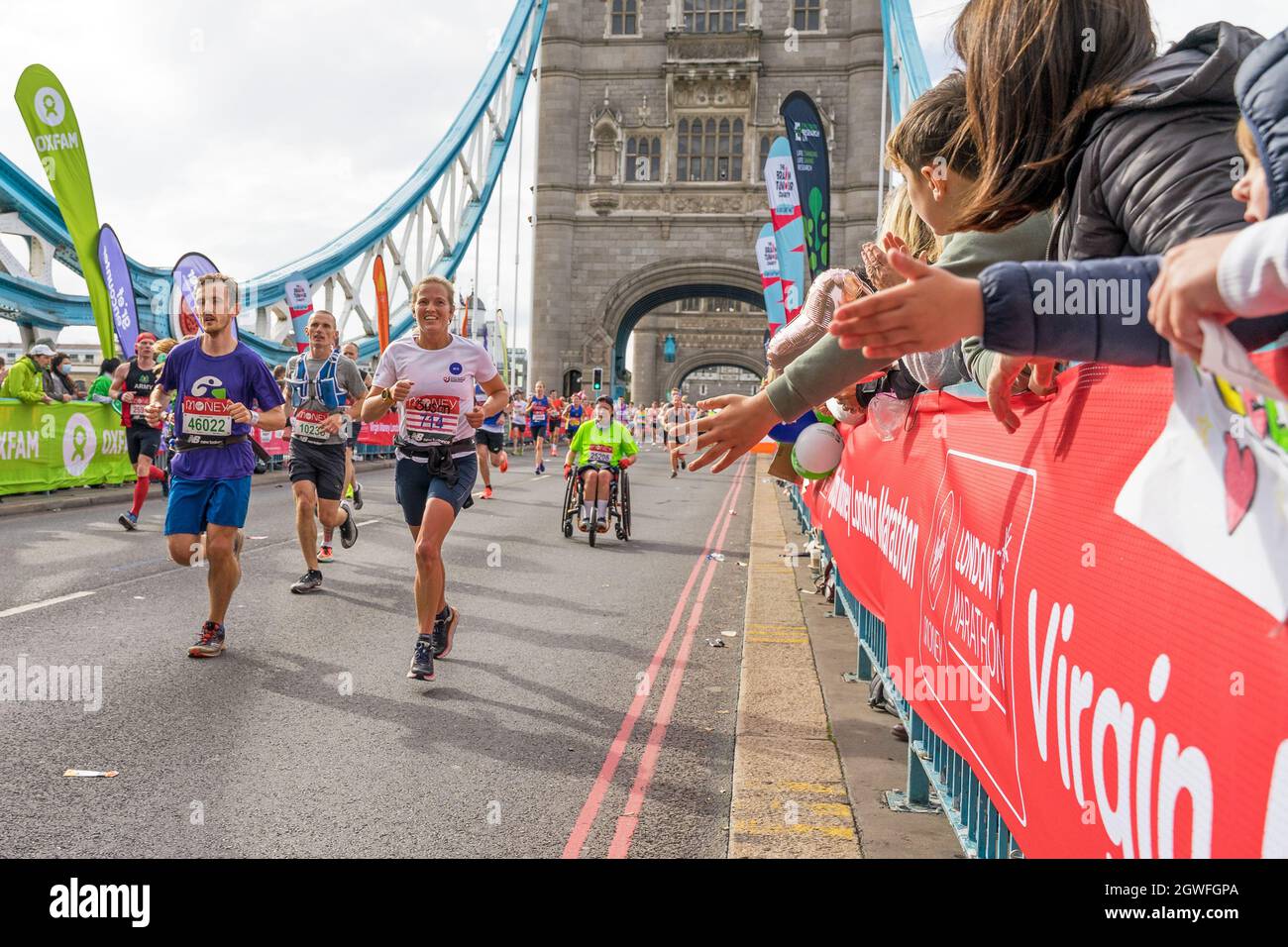 Runners completing the 41st London Marathon running over Tower Bridge