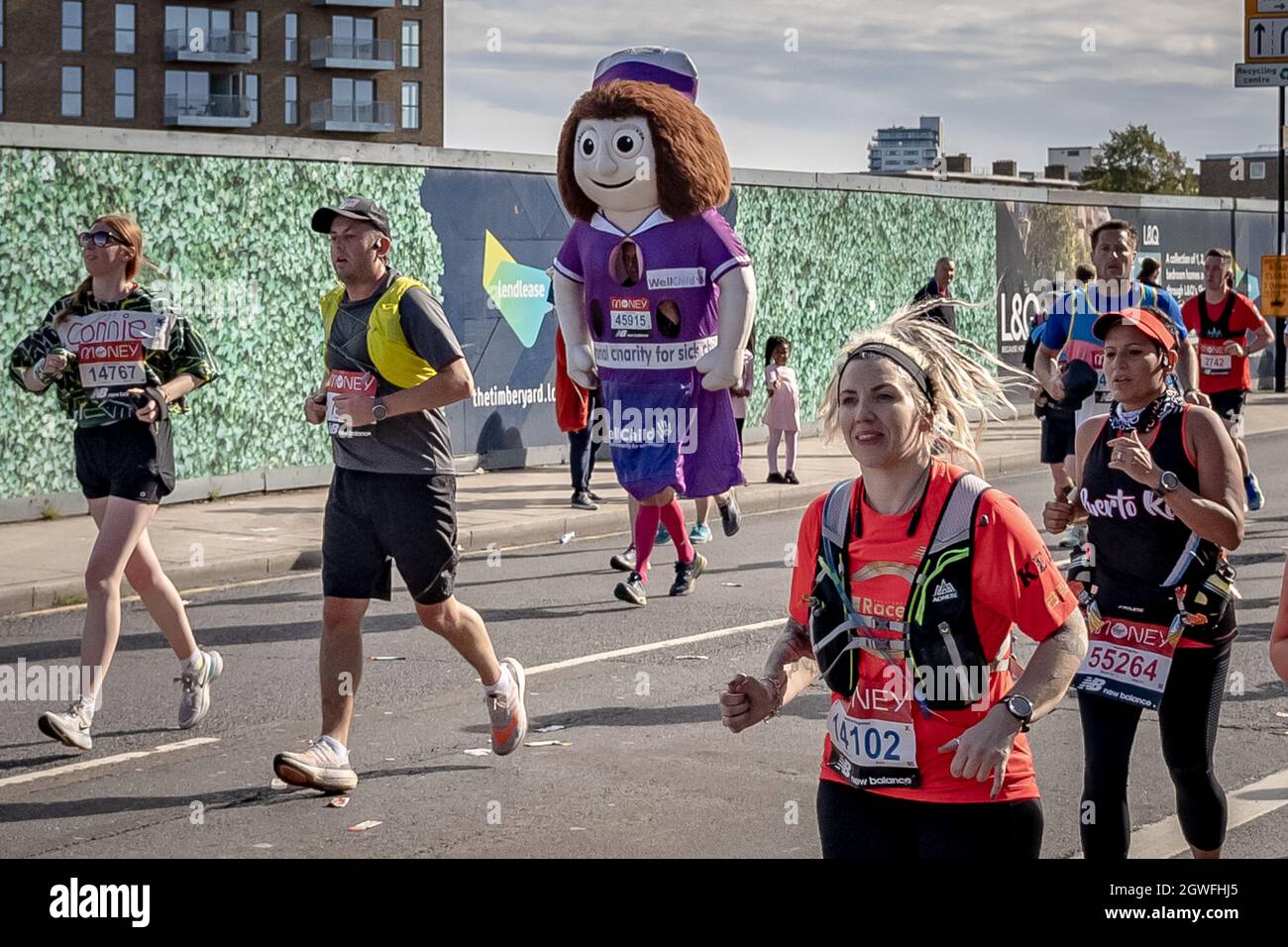 London, UK. 3rd Oct, 2021. Running for 'WellChild' the national UK charity for seriously ill children. London Marathon passes down Deptford’s Evelyn Street in South East London, the 8 mile mark of the 26.2 mile course where runners are greeted and cheered on by local residents. Up to 40,000 are expected to run with thousands joining virtually in what could be the biggest race in history. The event, which is now in its fifth decade, has helped raise more than £1bn for charities since it was first held in 1981. Credit: Guy Corbishley/Alamy Live News Stock Photo