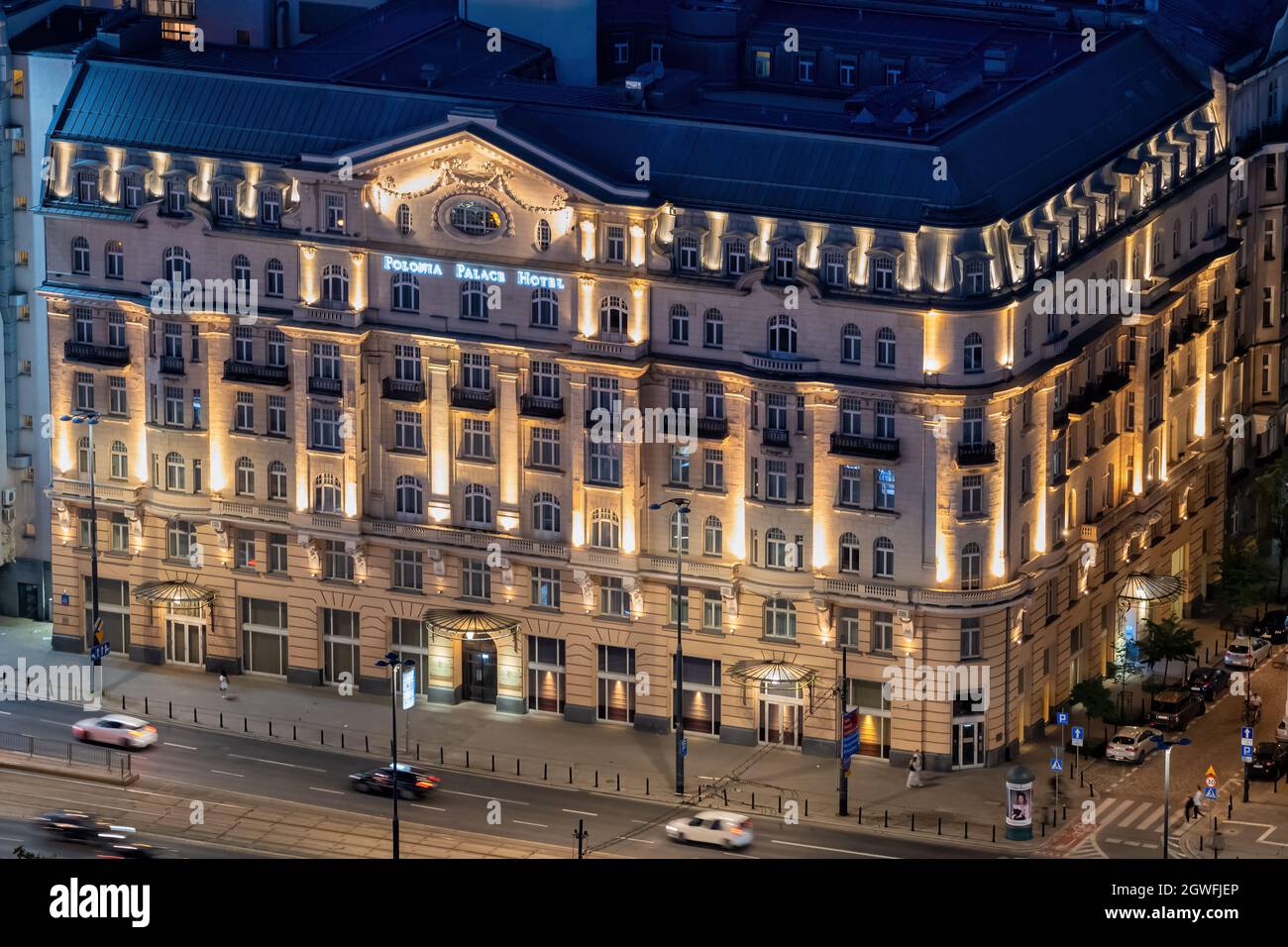 Hotel Polonia Palace illuminated at night in Warsaw Poland. Historic 4-star luxury accommodation in the city downtown. Stock Photo