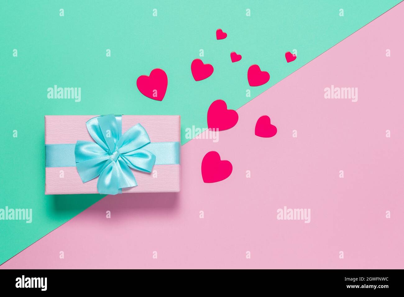 Pink Gift Box With Blue Bow On Pastel Two-color Background Pink And ...