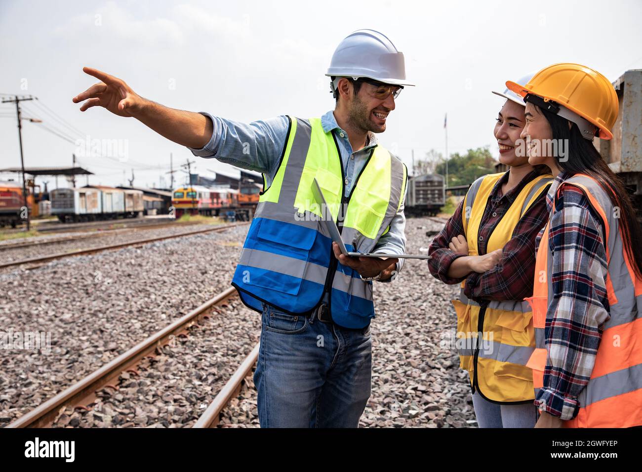 Engineers Working On Railway Train Statation And Holding Laptop For