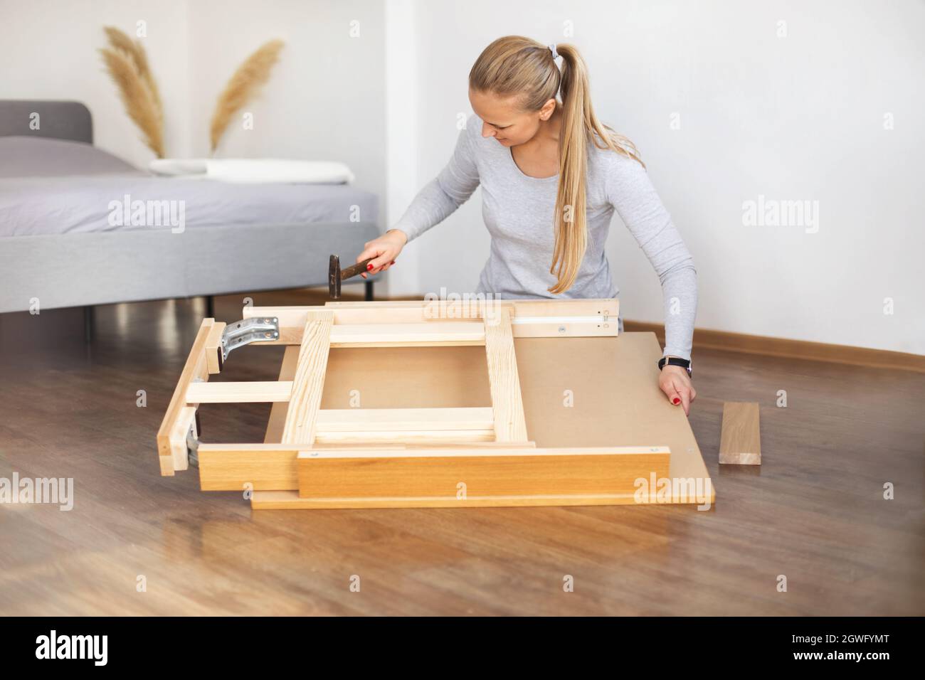 Woman Fixing Furniture At Home Stock Photo Alamy