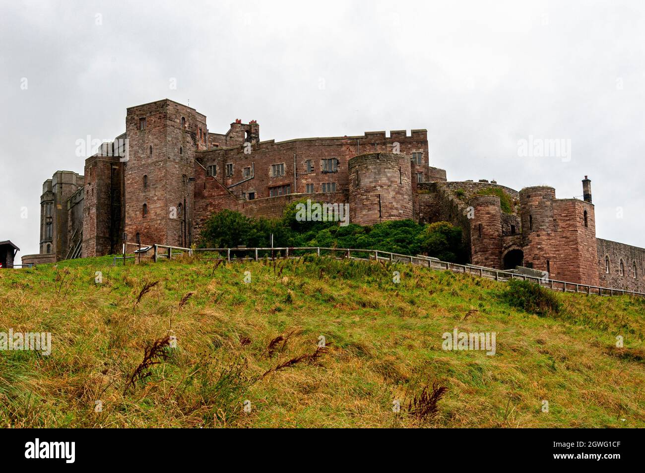 Bamburgh castle situated on a hilltop was built around an 11th-century Norman keep by Henry ll and restored in the 19th century by Lord Armstrong Stock Photo