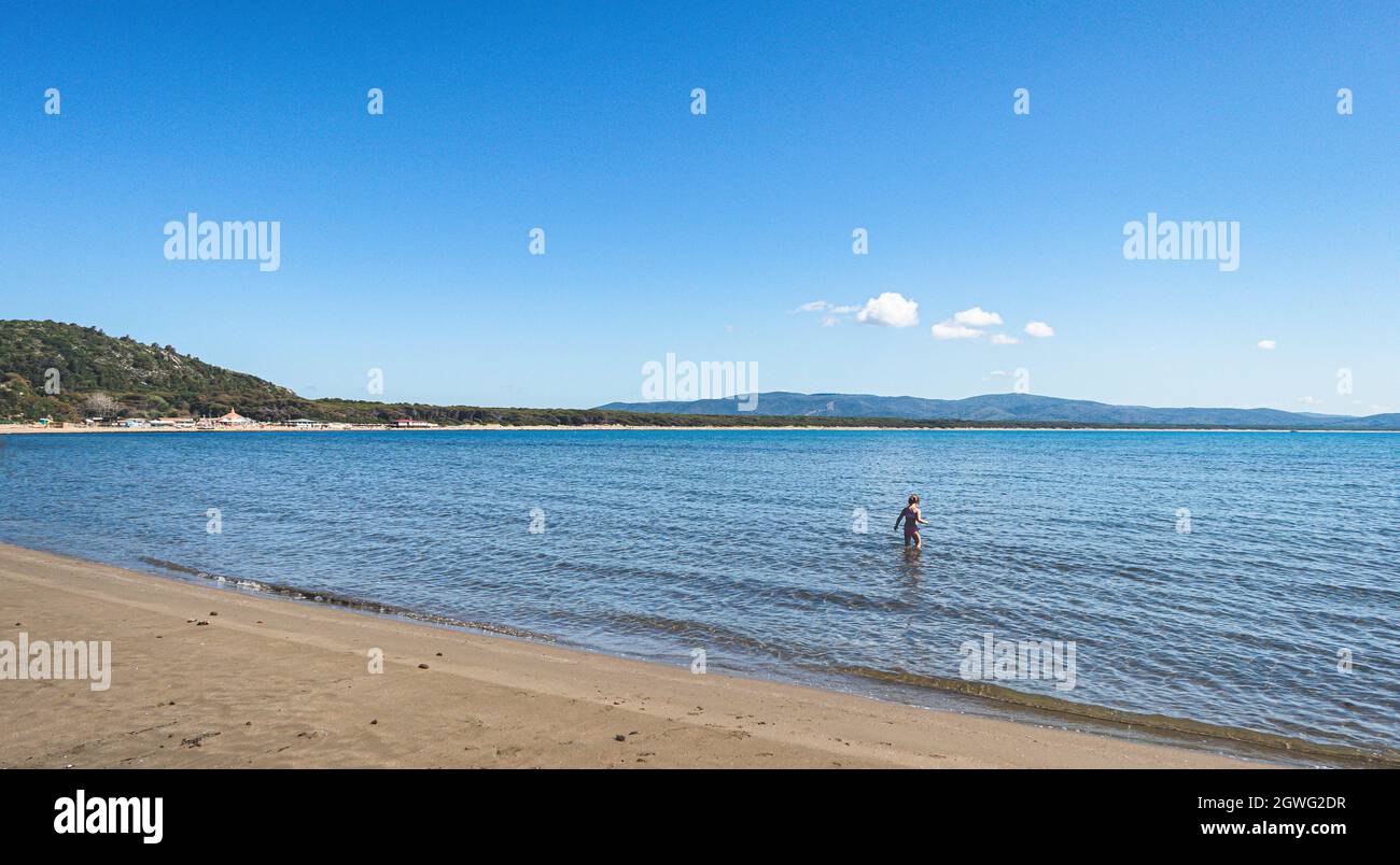 Girl In Sea Against Blue Sky Stock Photo