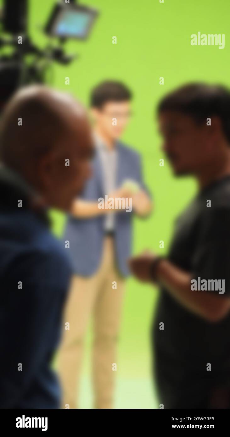 Blurry images of making TV commercial movie video in big green screen
