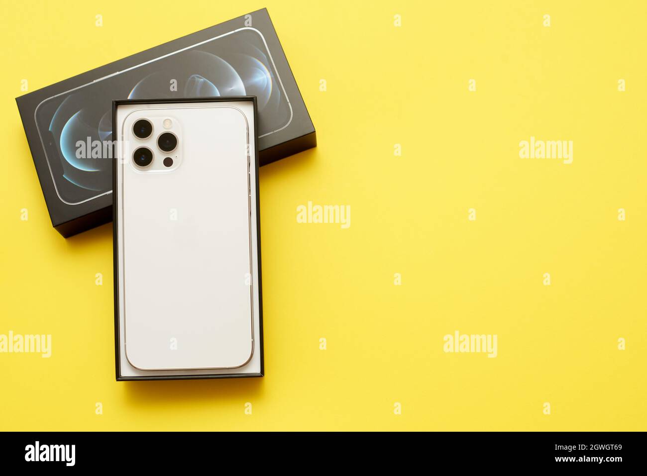 STARIY OSKOL, RUSSIA - JULY 5, 2021: Unboxing new iPhone 12 pro max on a  yellow background with copy space Stock Photo - Alamy