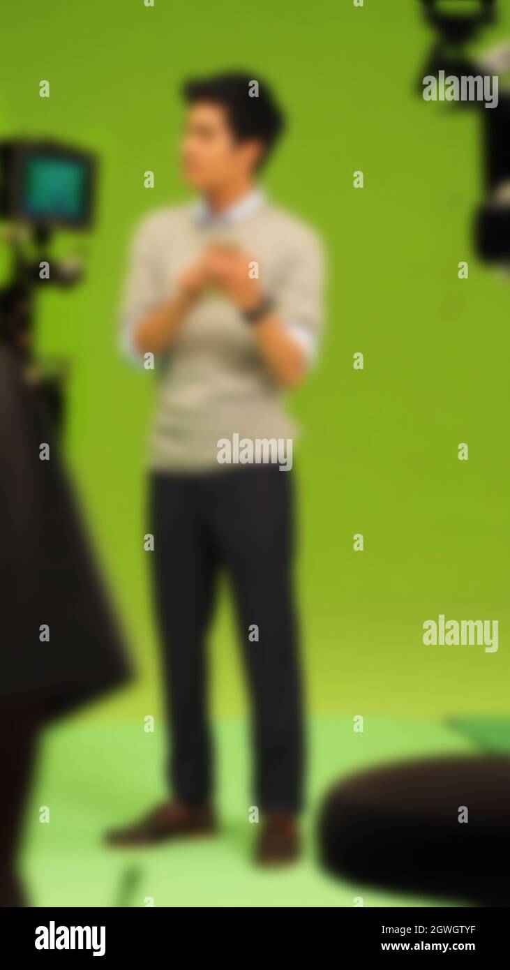 Blurry images of making TV commercial movie video in big green screen