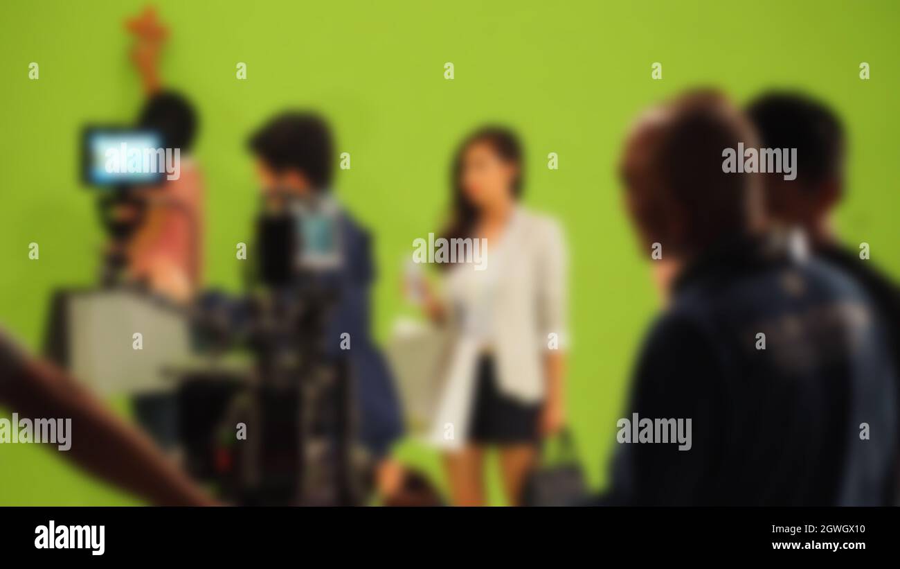 Blurry images of making TV commercial movie video in big green screen
