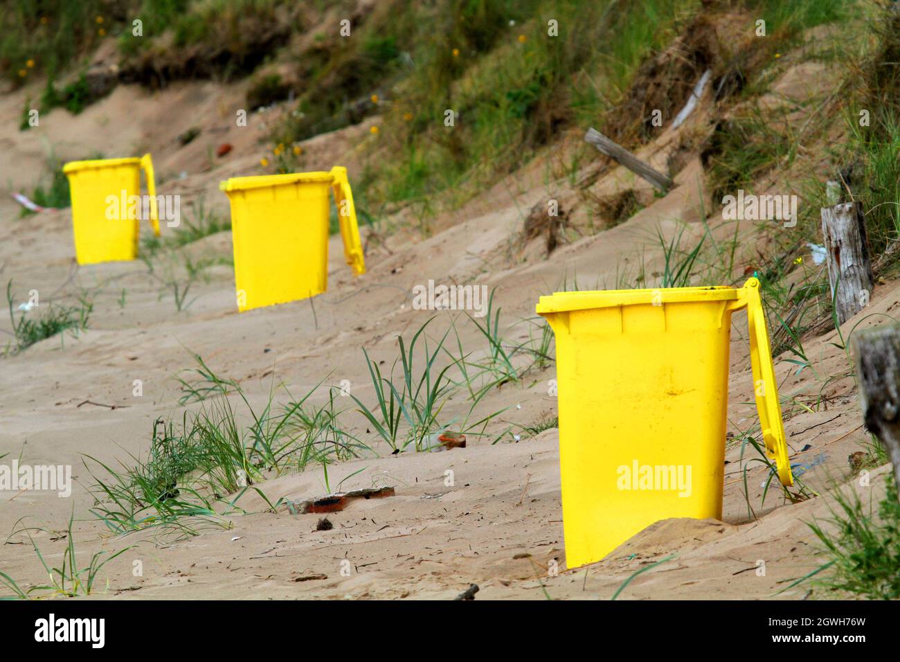 Irvine Beah, Irvine, Ayrshire, Scotland, UK. Bright yellow wheelie bin