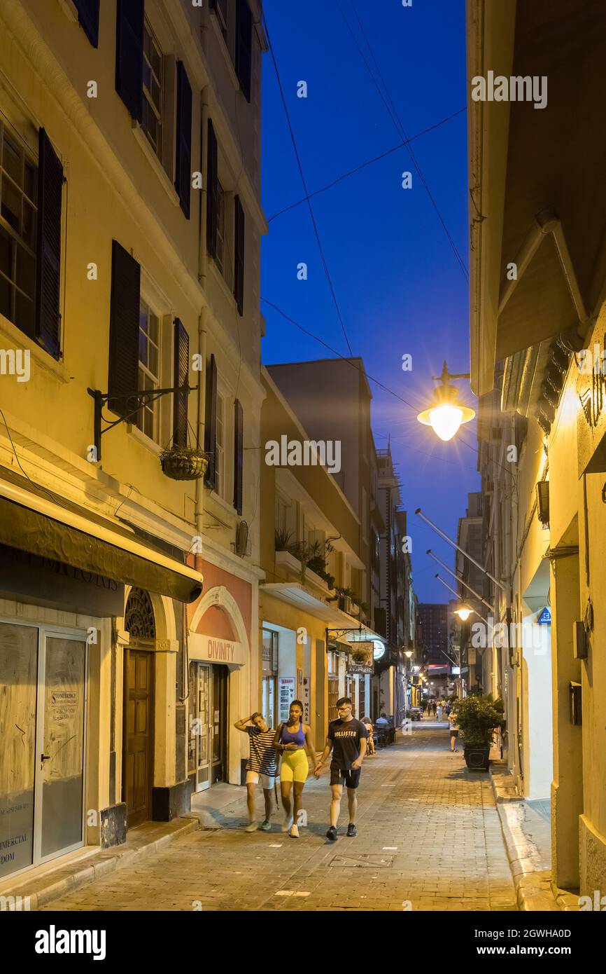 People walking down side street in main town, Gibraltar Stock Photo