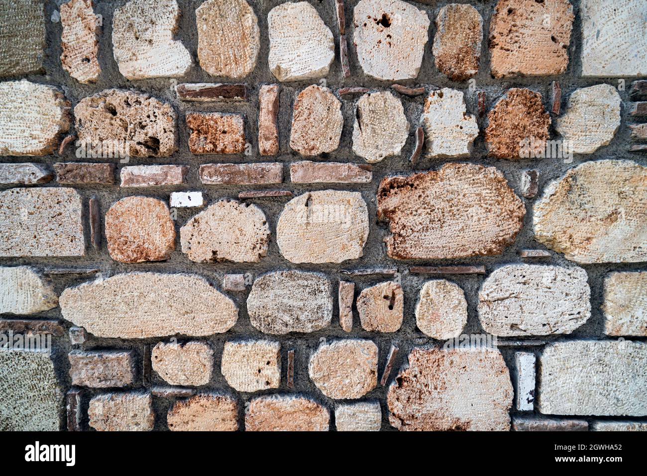stone texture, stone wall background. an old shabby wall made of stone textured blocks. Stock Photo