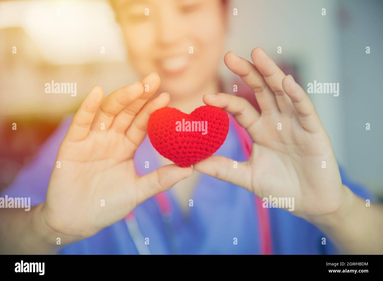 nurse sharing love red heart for health care giving medical help and donation together concept Stock Photo