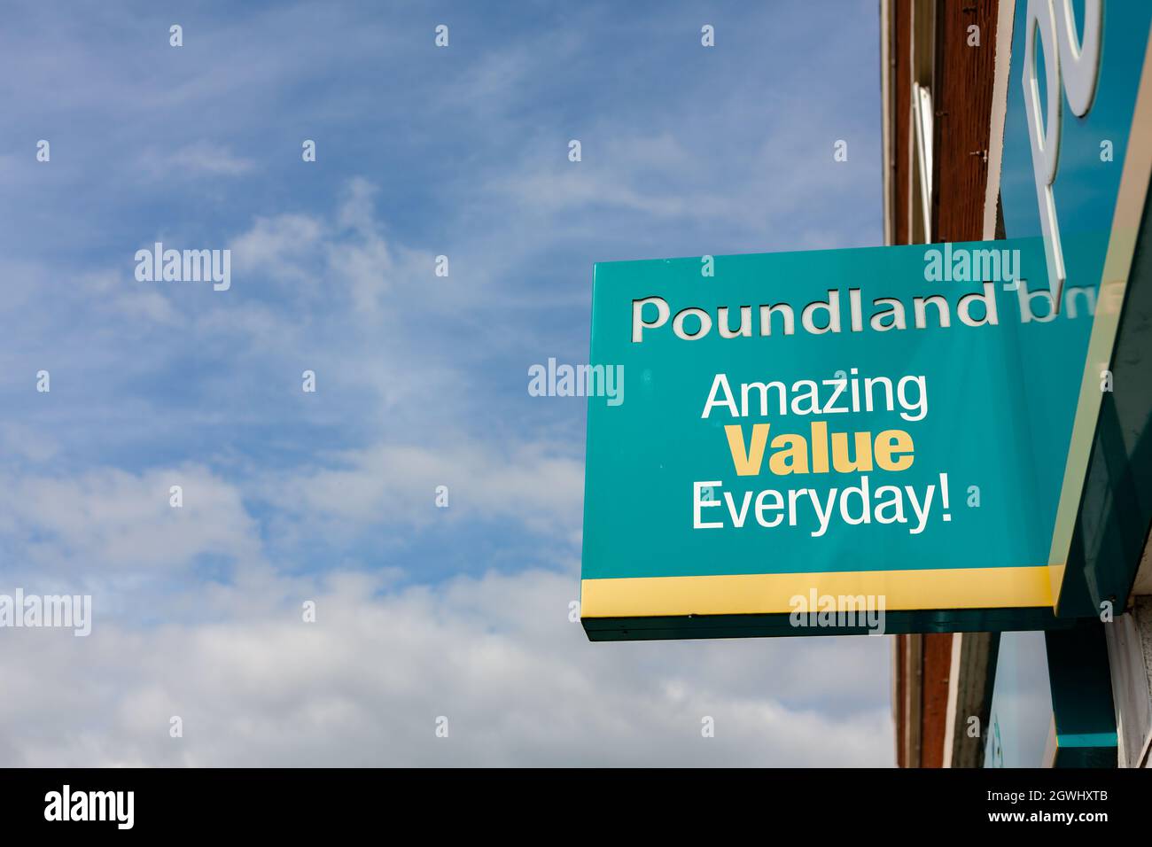 Felixstowe Suffolk UK September 17 2021: Poundland store logo front of shop isolated against a clear blue summer sky Stock Photo