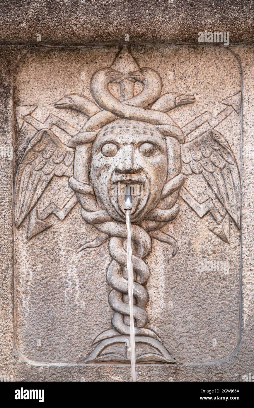 Close-up of an ancient fountain with a caduceus sculpture Stock Photo -  Alamy