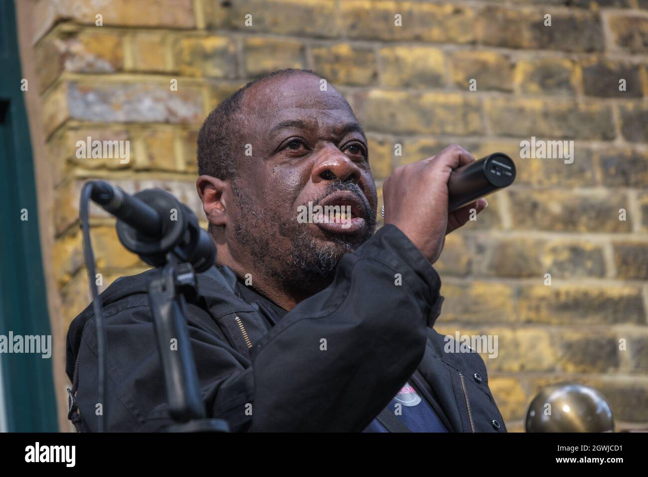London, UK. 3rd Oct 2021. Weyman Bennett of Stand Up to Racism speaking at the rally on the 85th anniversary of the Battle of Cable St to remember the act of unity against the fascist threat when the Jewish and Irish communities of East London and their allies blocked the streets to prevent Oswald Mosley and his British Union of Fascists marching through. They marched from Dock St along Cable St to a rally next to the mural in St George's Gardens chaired by Jewish historian David Rosenberg and local Bengali activist Julie Begum. Peter Marshall/Alamy Live News Stock Photo