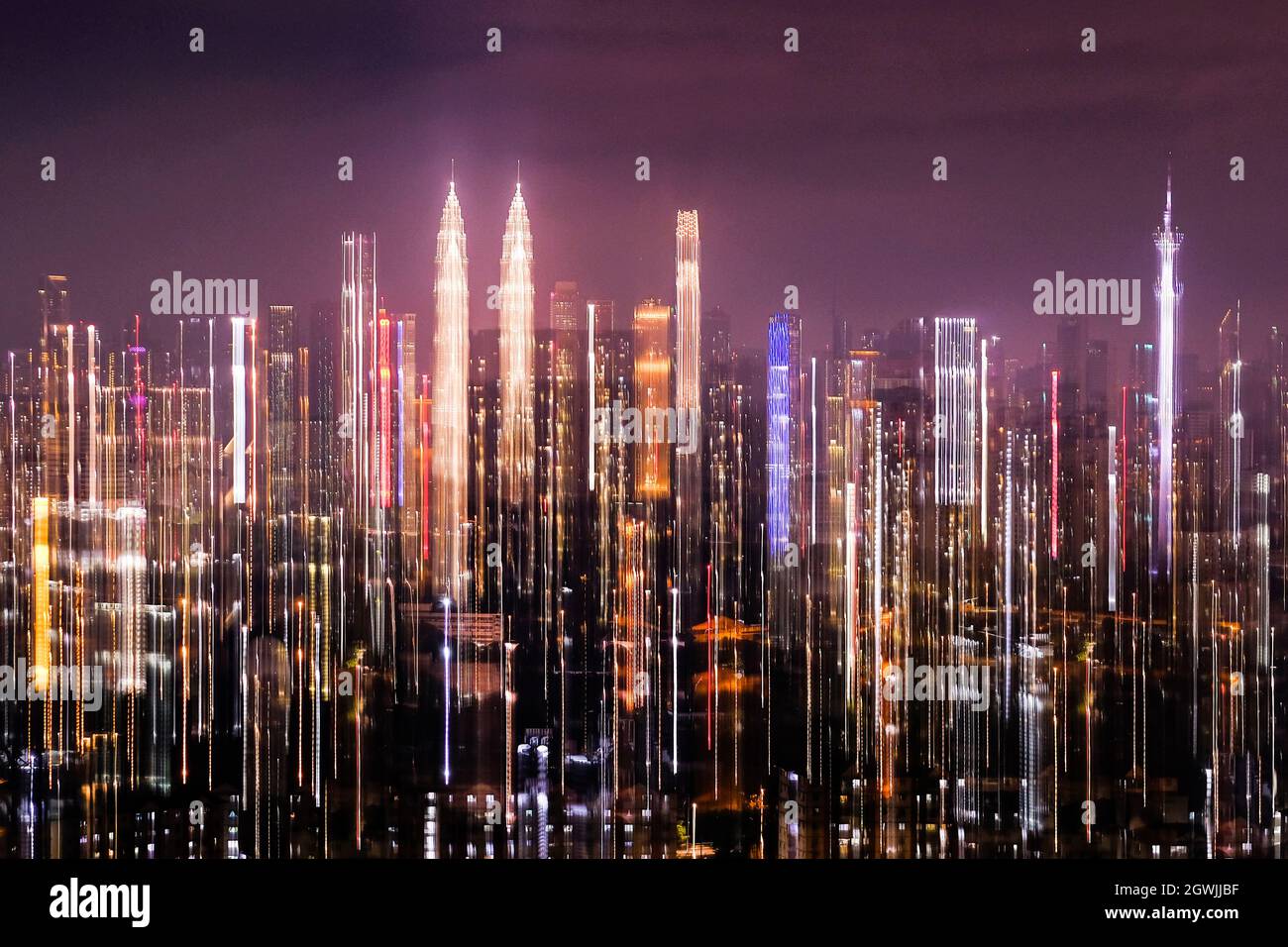 Illuminated Modern Buildings Against Sky At Night Stock Photo