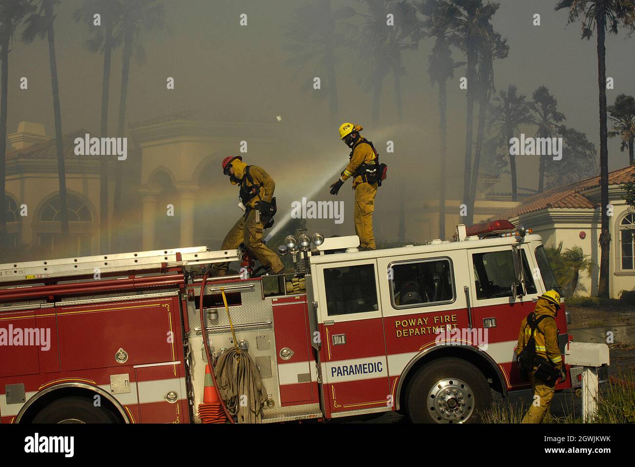Poway Firefighters work at containing flames from the Witch Creek fire