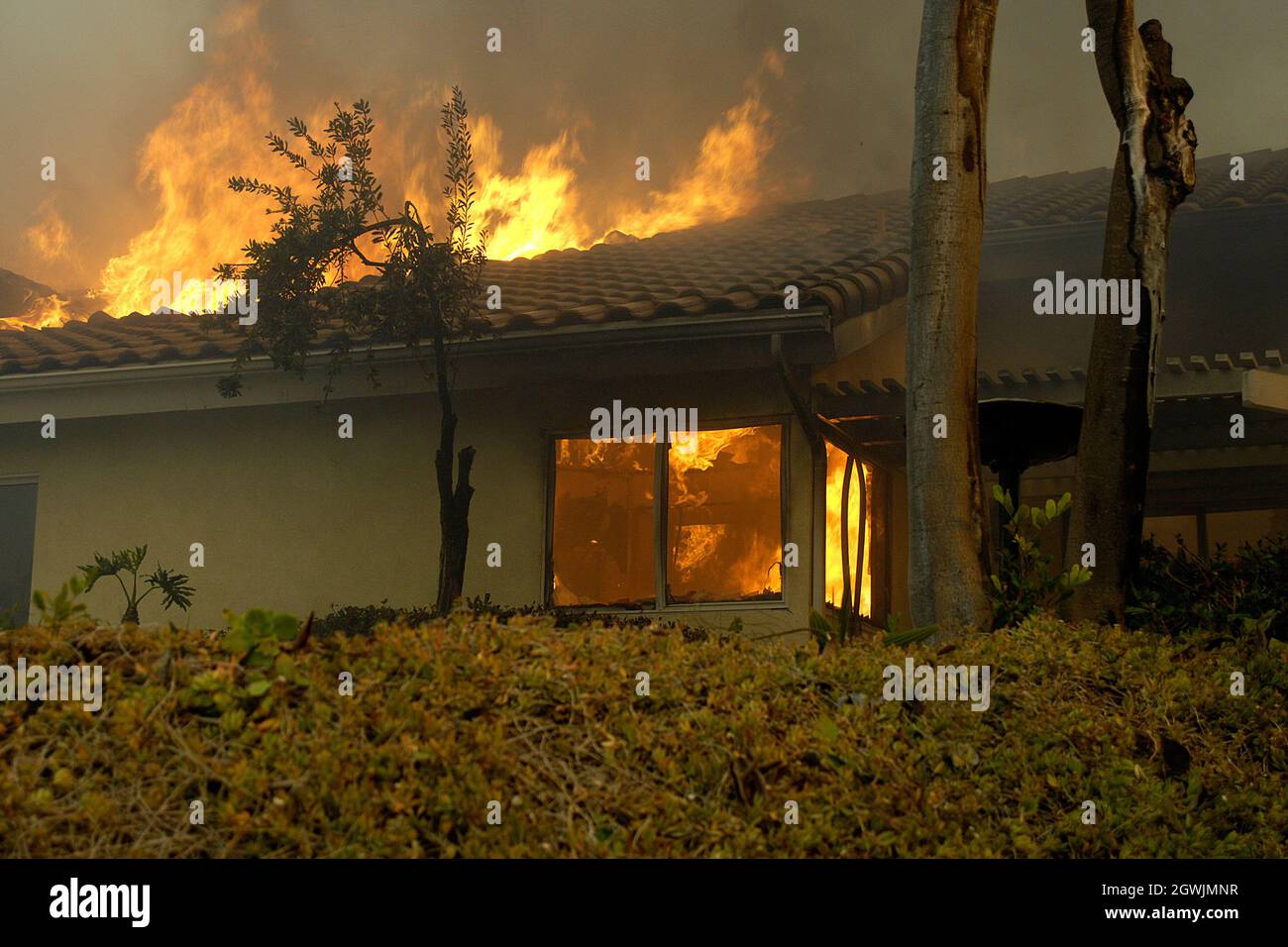 House burns during Witch Creek Fire in San Diego, California, 2007. Embers going under eves ignited structure. Stock Photo