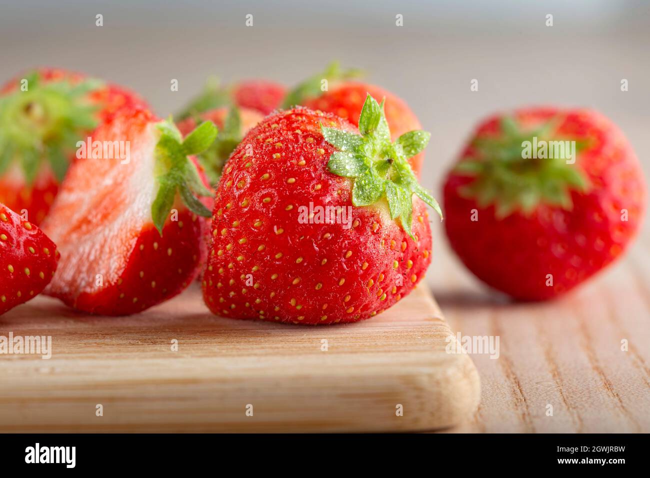 Fresh strawberries with water drops on wood background Stock Photo
