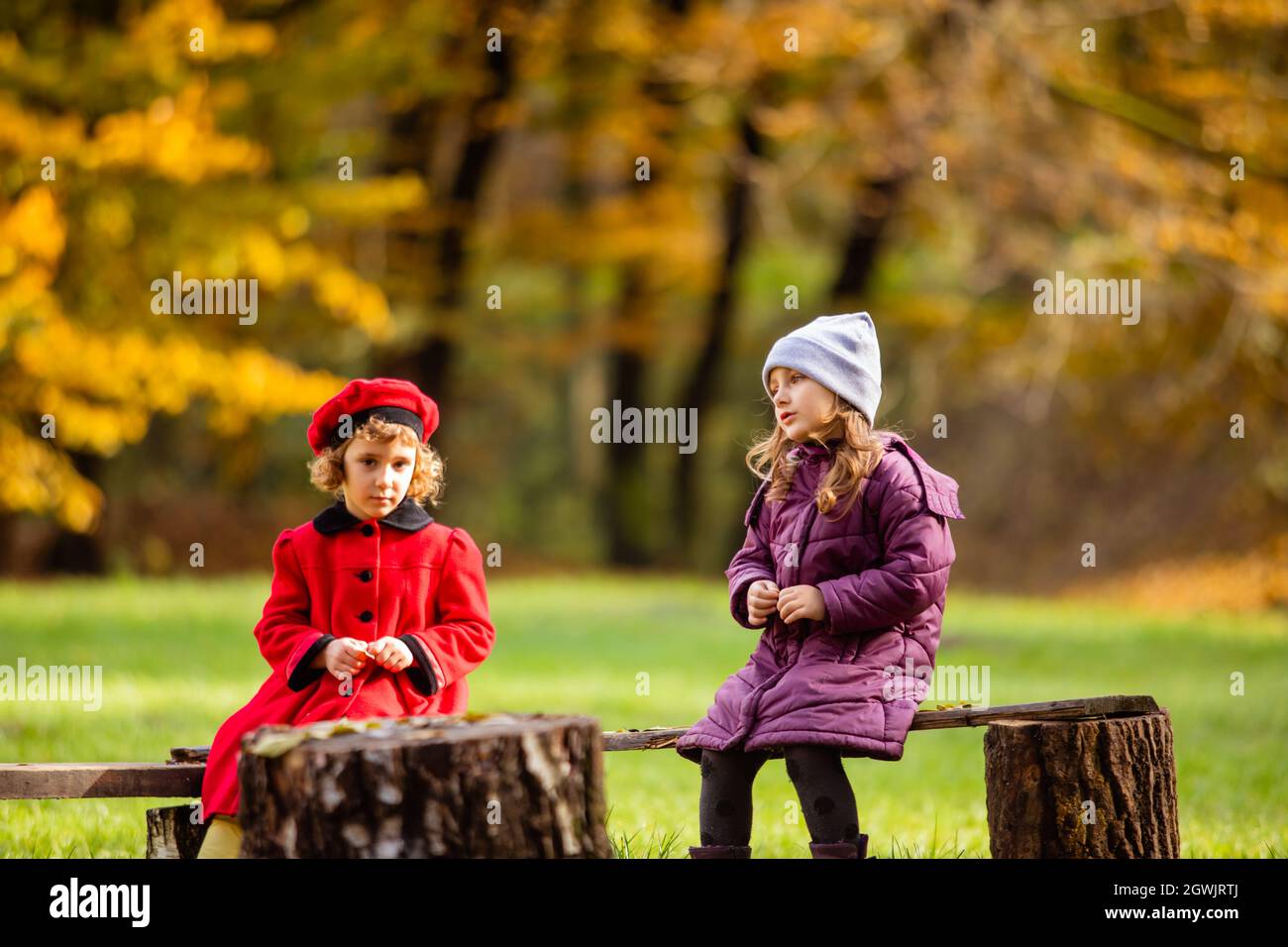 Cute Kids Sitting On Bench Stock Photo Alamy