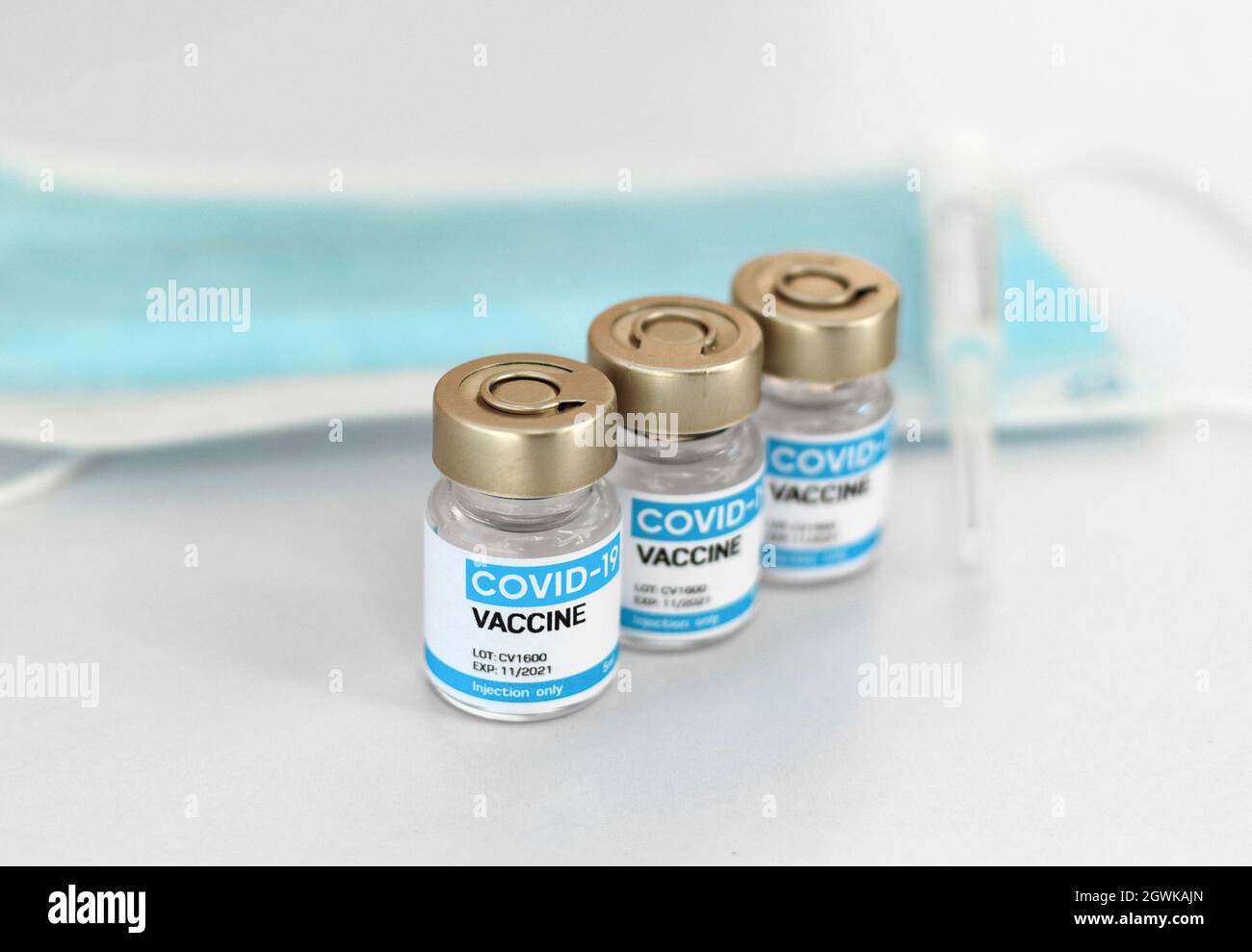 Close-up Image Of Covid Vaccines And Syringe On White Background. Stock Photo
