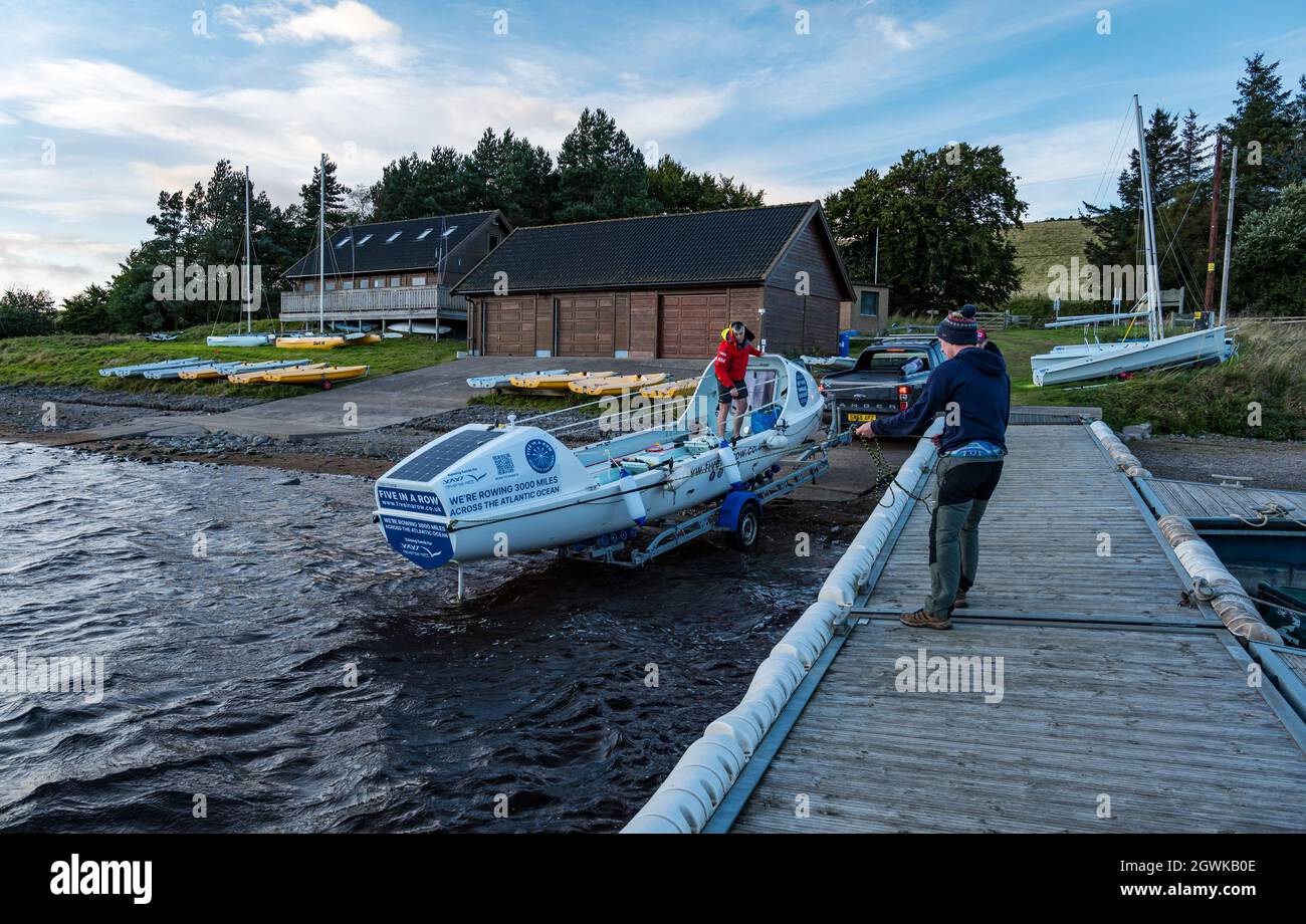 Men launch ocean rowing boat on Whiteadder Reservoir for a training session for Atlantic