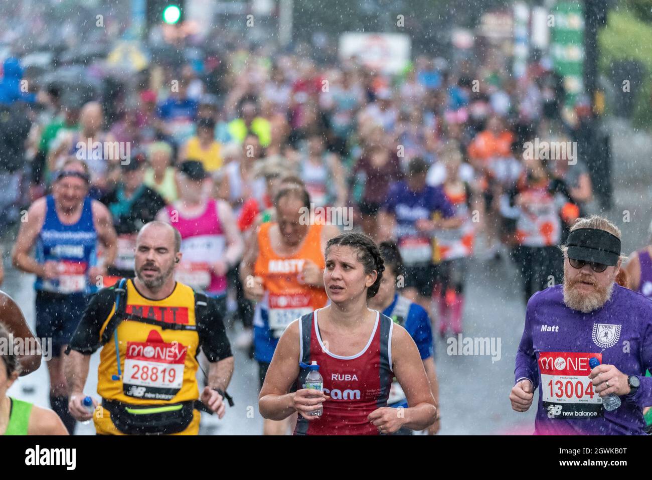 Tower Hill, London, UK. 3rd Oct, 2021. Heavy rain hit late on in the Virgin Money London Marathon 2021 as the fun runners passed through Tower Hill. Stock Photo