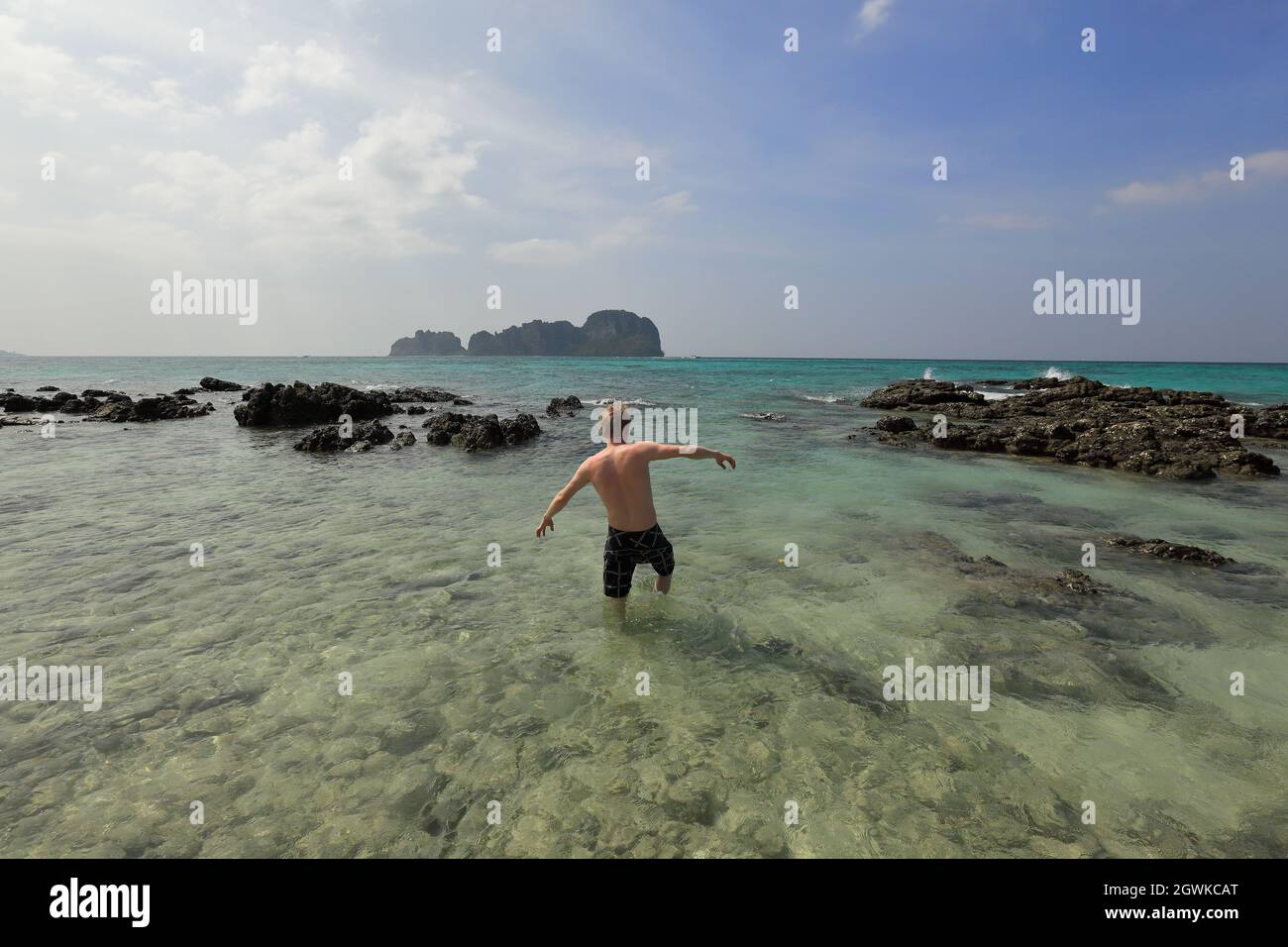 Walking on sunny tropical beach in Thailand Stock Photo