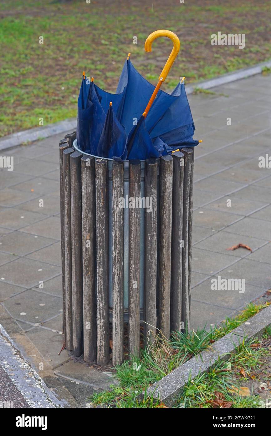 Broken wet umbrella in garbage trash bin Stock Photo Alamy