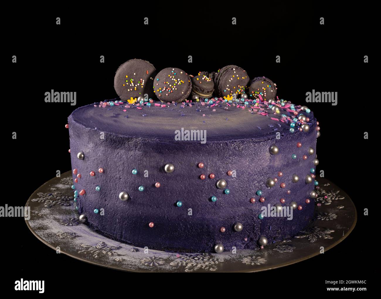 Handmade purple cake with french macarons decorations Stock Photo