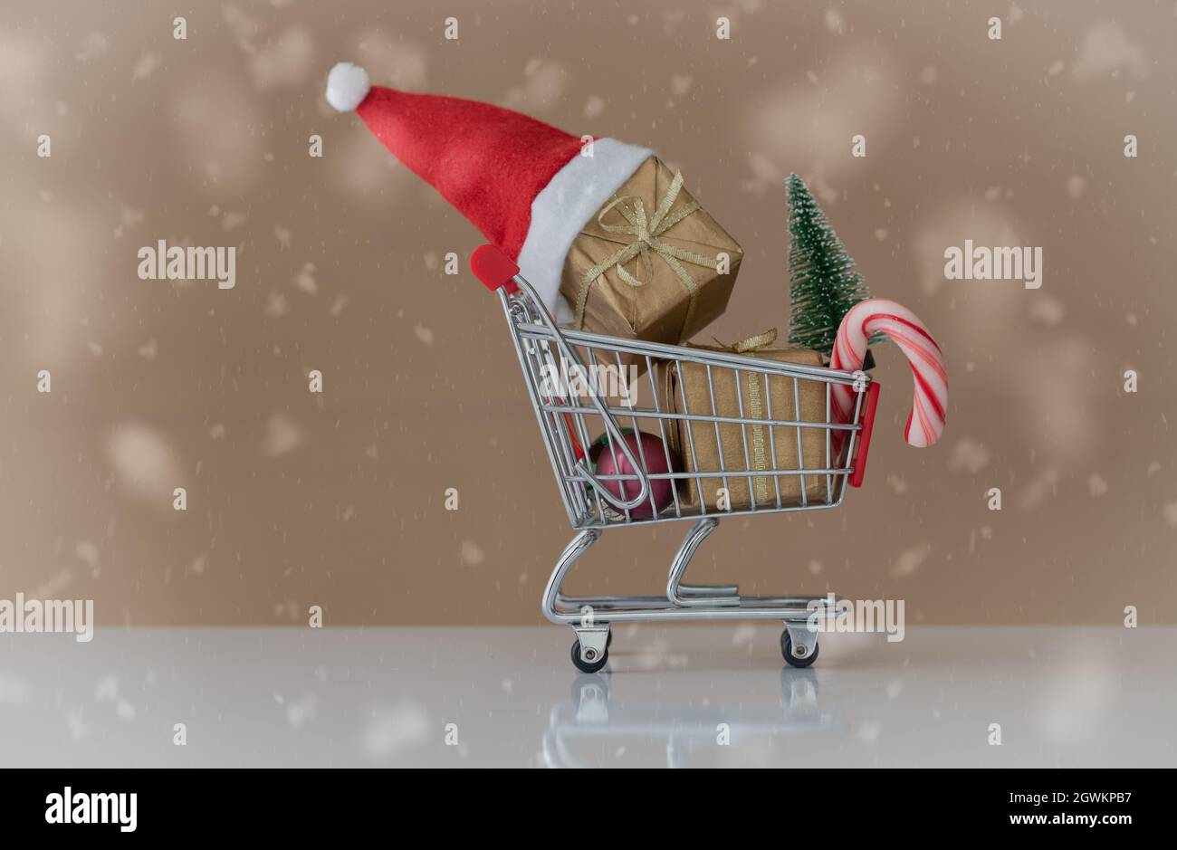 little shopping cart with christmas gifts as a concept for buying in time Stock Photo
