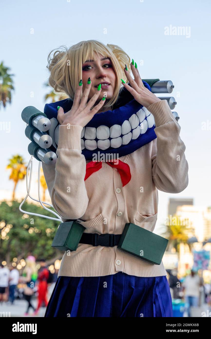 Cosplayer in My Hero Academia League of Villains Himiko Toga Costume JK School Uniform Sweater with Neckwear and Face Covering at Comic Con LA, USA Stock Photo