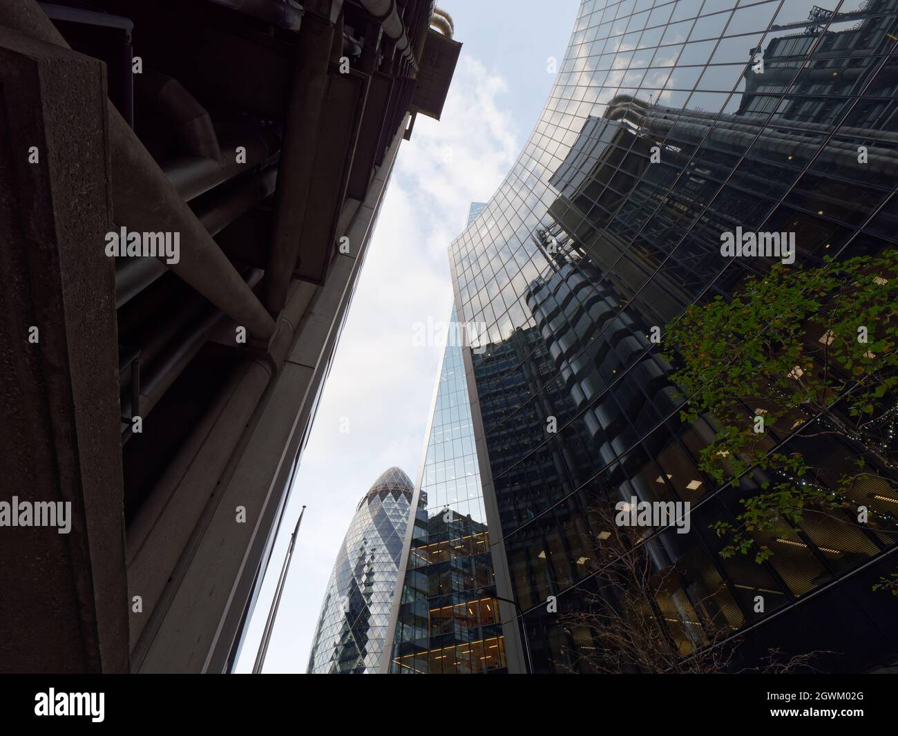 London, Greater London, England, September 21 2021: 30 St Marys Axe skyscraper aka The Gherkin plus other modern buildings as seen from Lime Street. Stock Photo