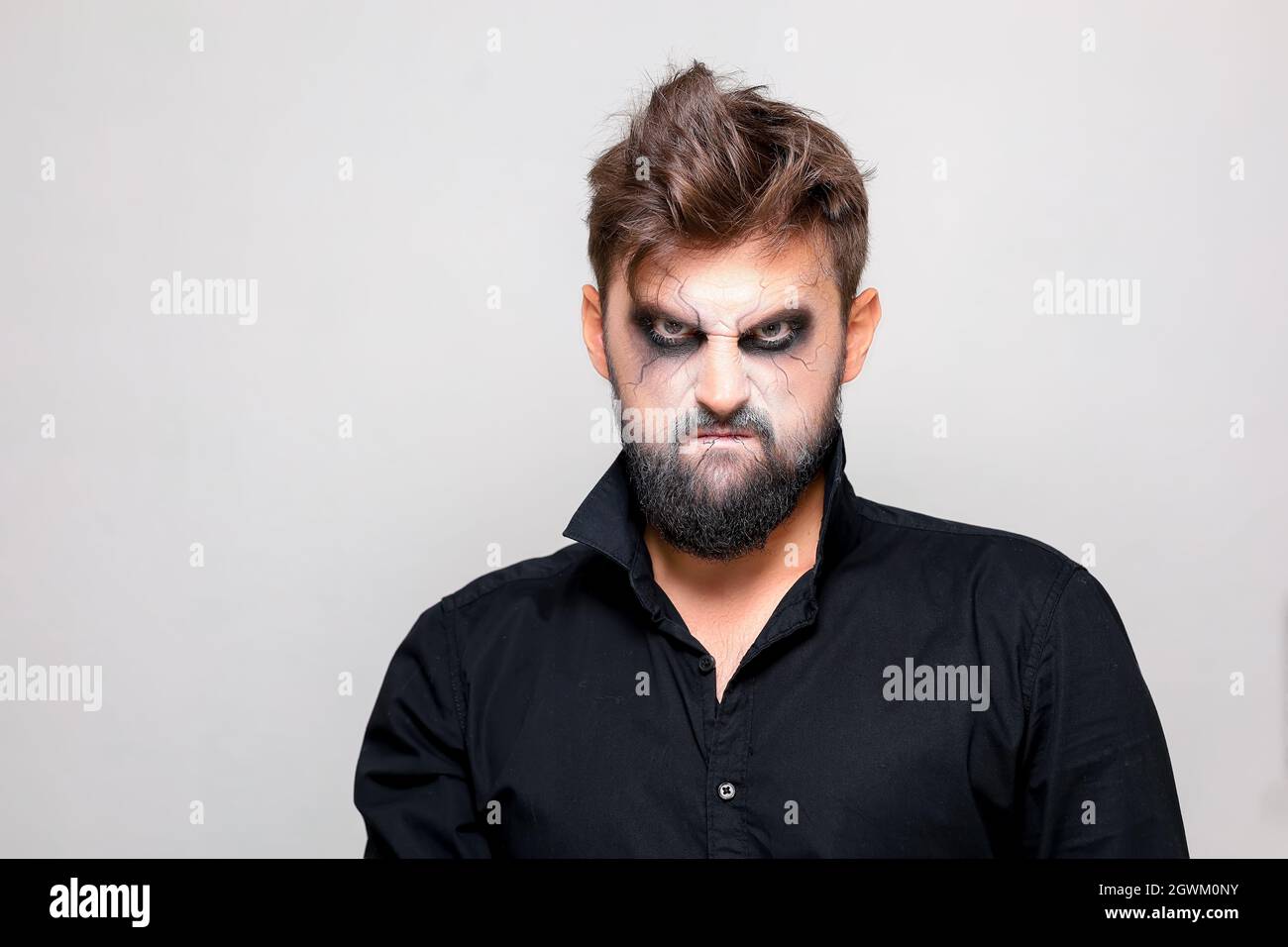 bearded men with makeup for Halloween looks at the camera Stock Photo