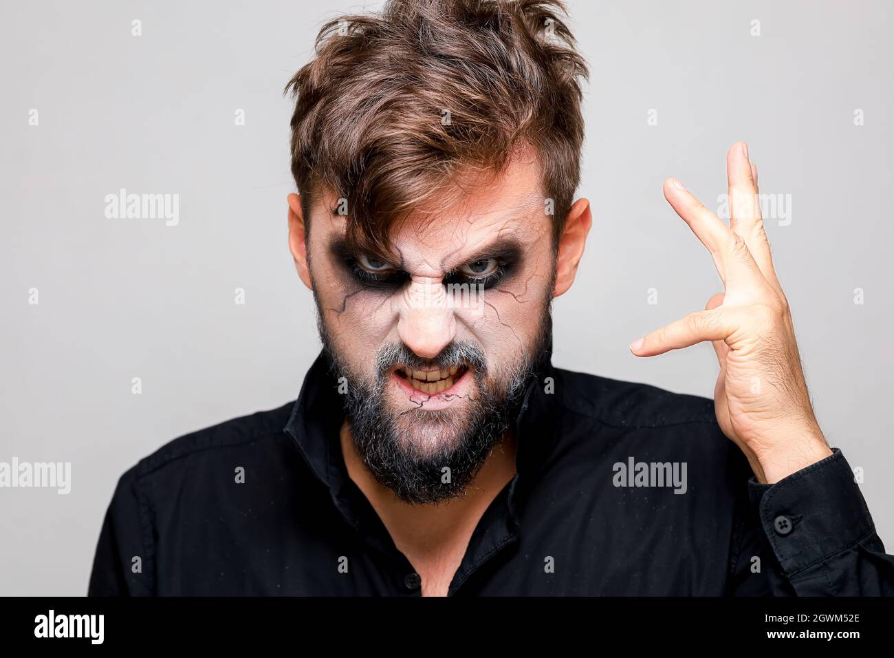 The frightening look of a bearded man with undead-style makeup for Halloween Stock Photo