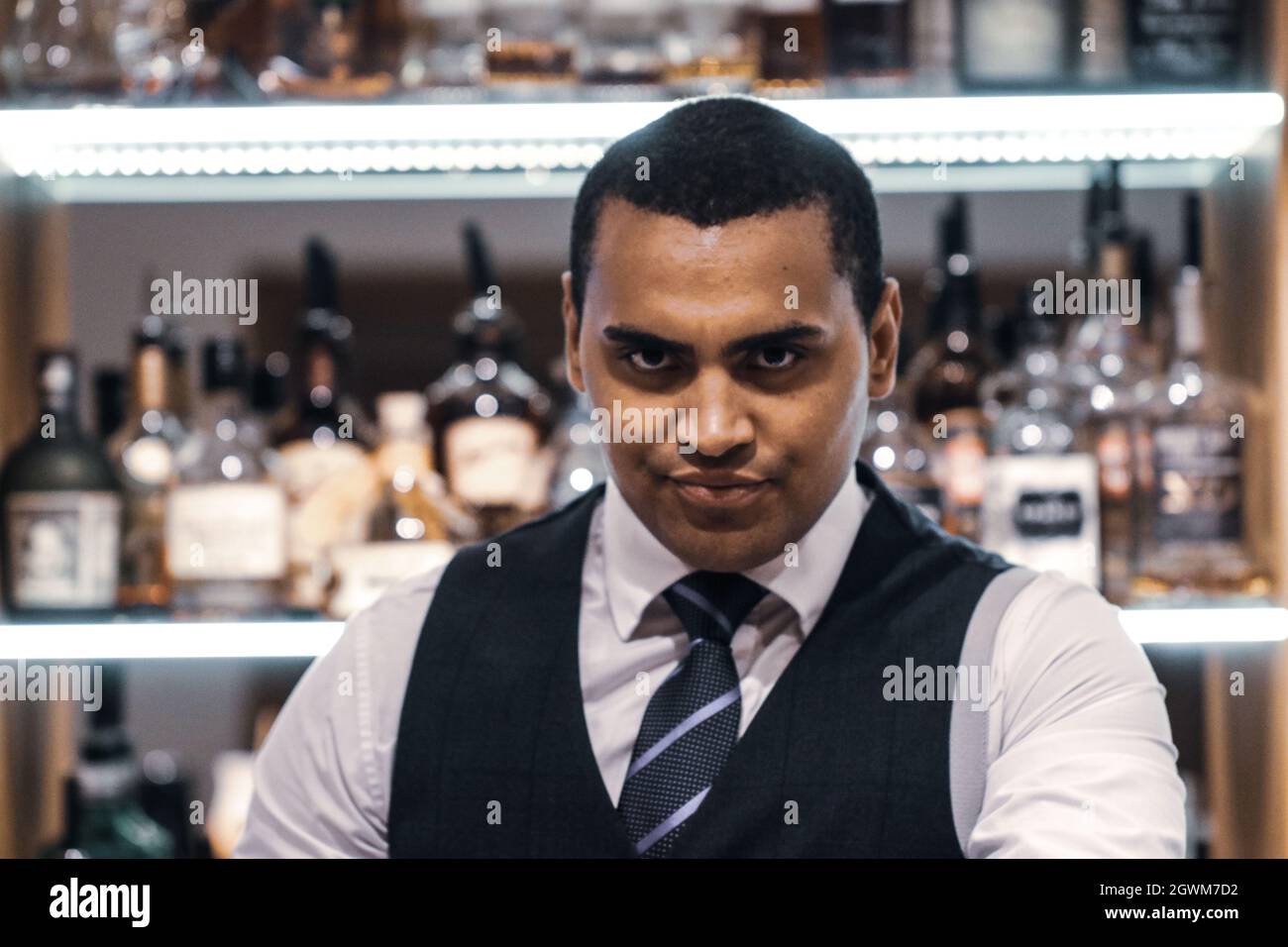 Portrait Of Confident Bar Tender At Home Stock Photo