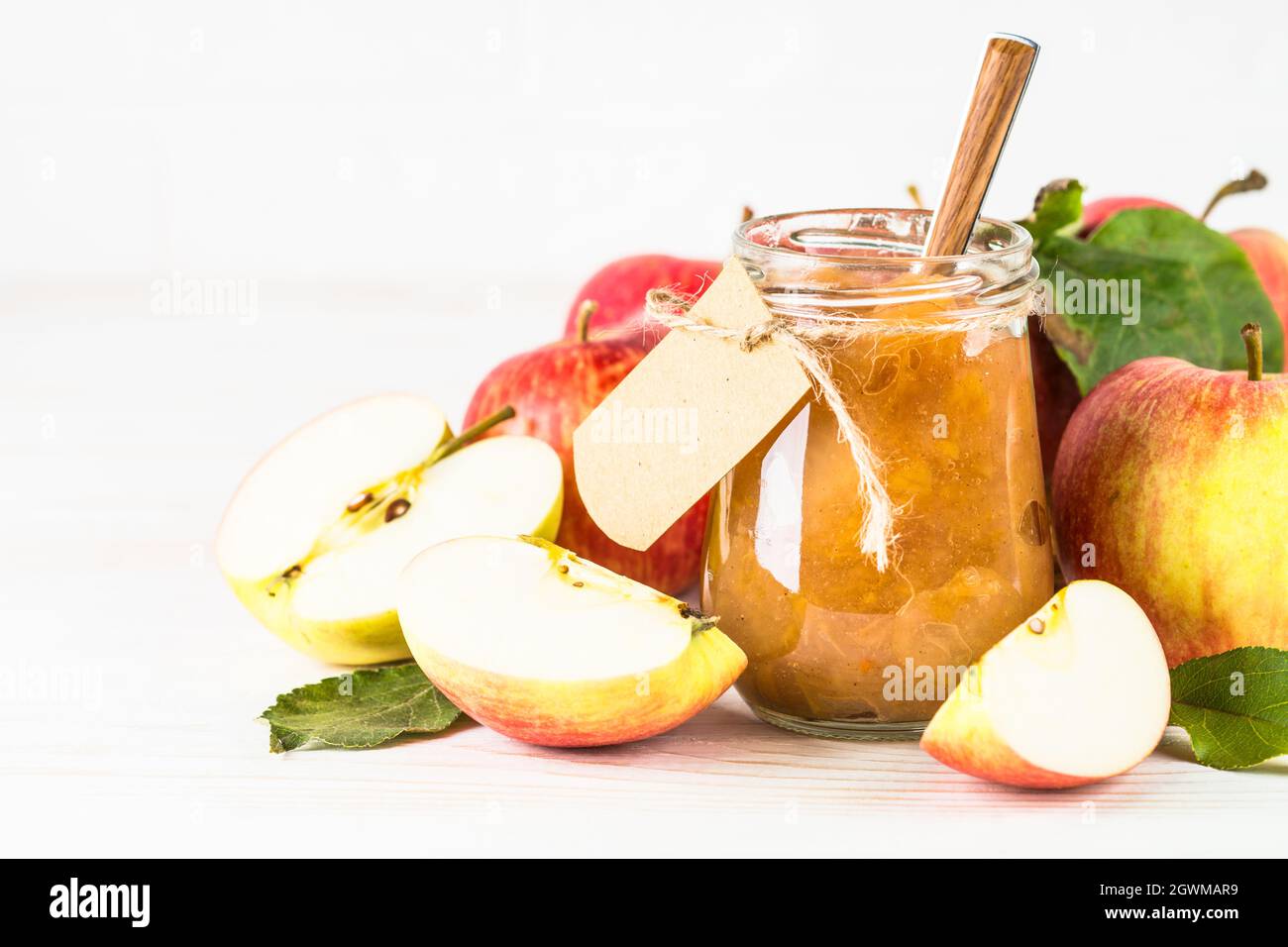 Apple jam with fresh apples on white background. Stock Photo