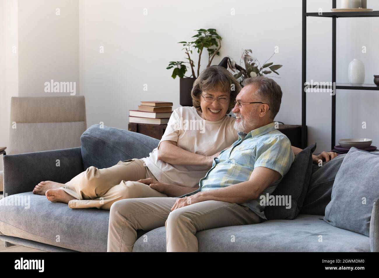 Affectionate smiling middle aged couple resting on cozy sofa Stock ...