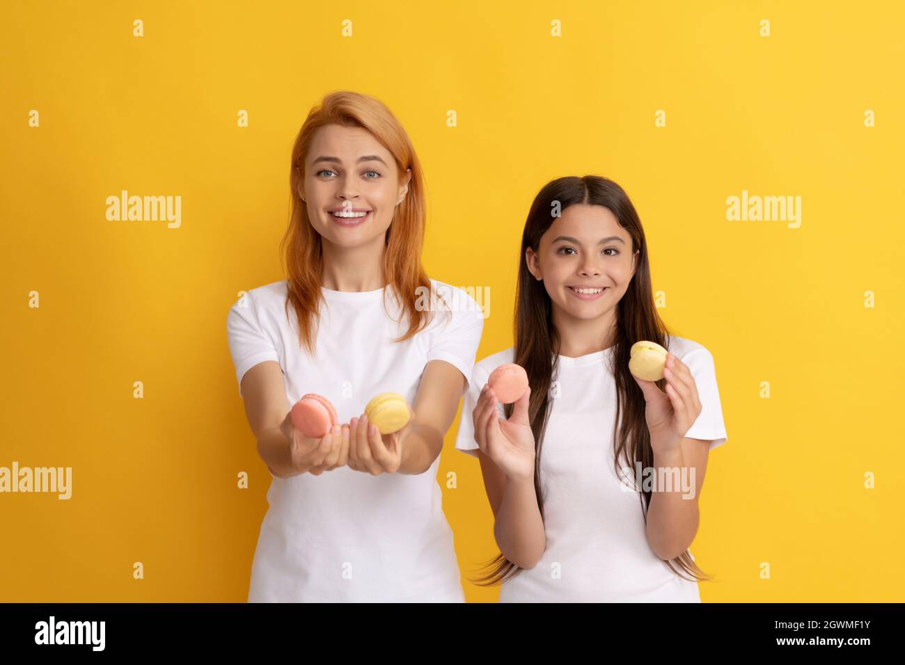 happy family of woman and teen girl hold french macaron cookies, french macaroon Stock Photo