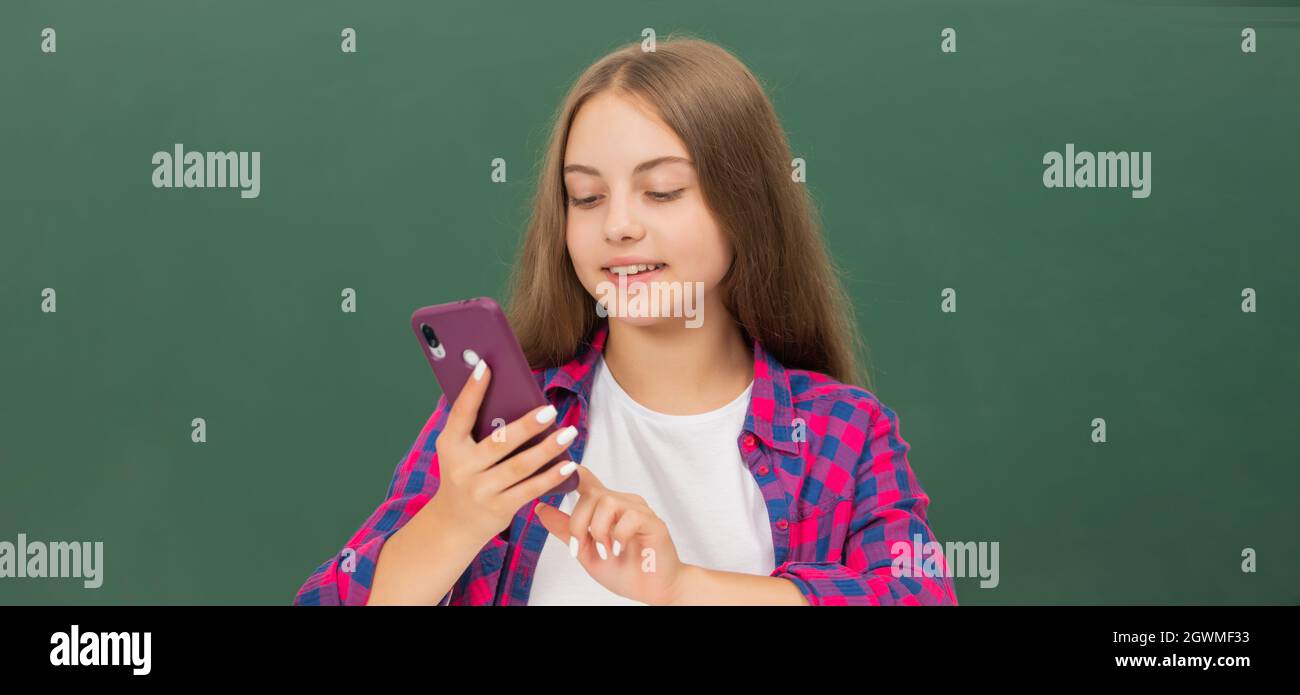 smiling teen girl blogger use smartphone. back to school. education app. kid chat online Stock Photo