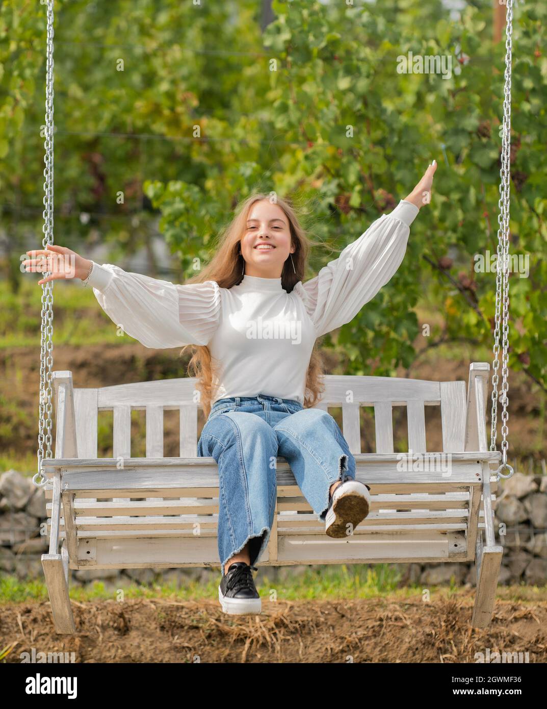 cheerful child swinging on swing outdoor, childhood Stock Photo Alamy