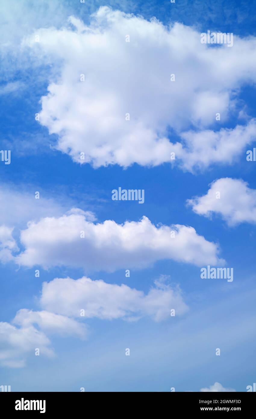 White Fluffy Clouds Floating on Vibrant Blue Sky Stock Photo - Alamy