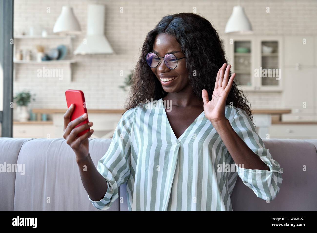 African black happy female student having videocall videoconference on phone. Stock Photo