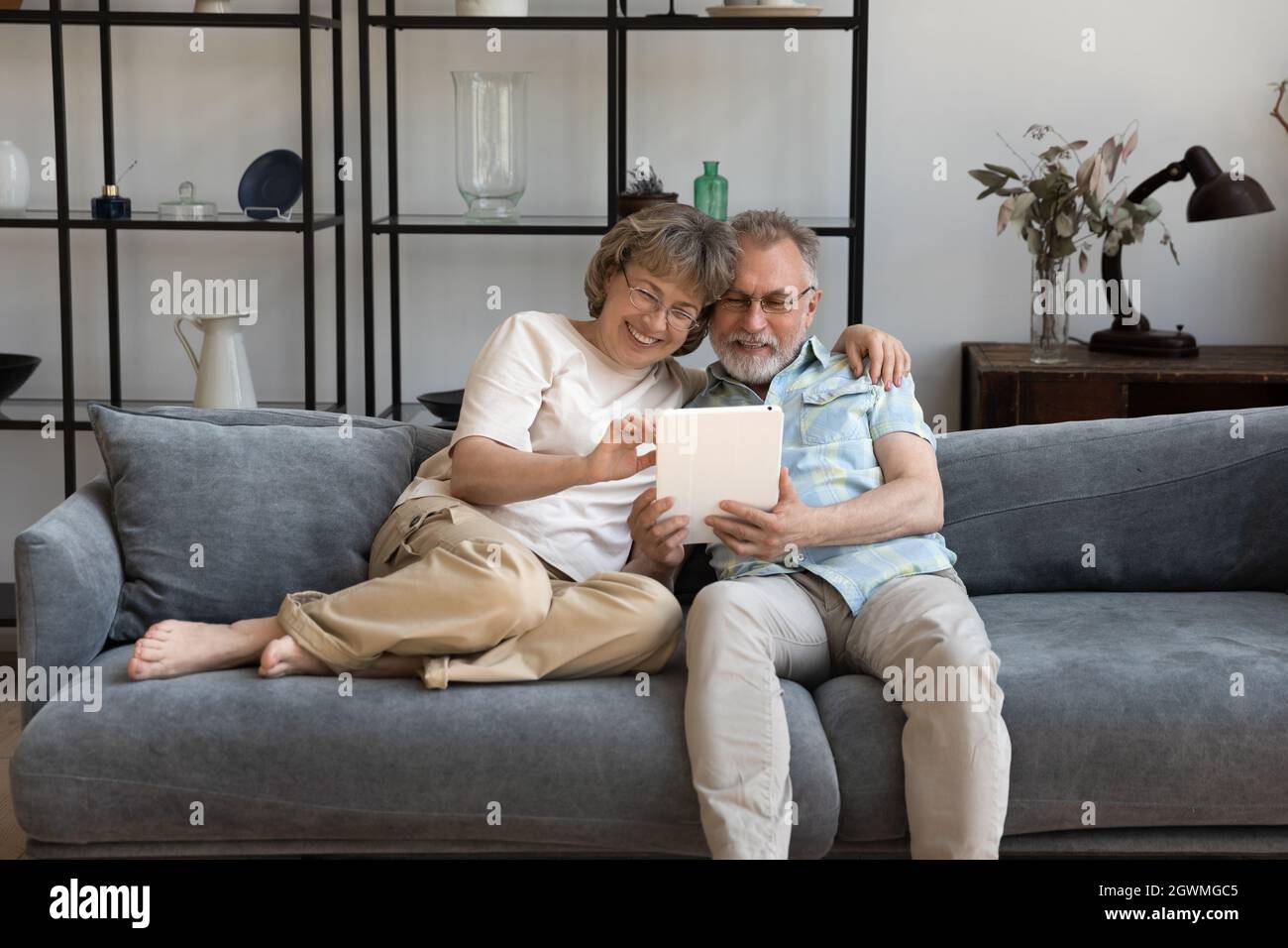 Happy bonding mature couple using digital tablet. Stock Photo
