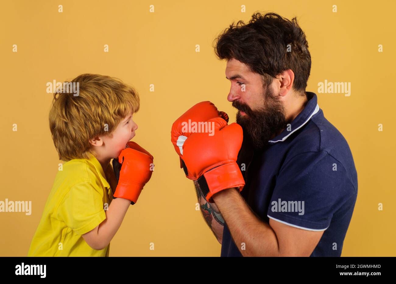Little kid boxing with coach. Sport lifestyle. Training together. Family workout. Father