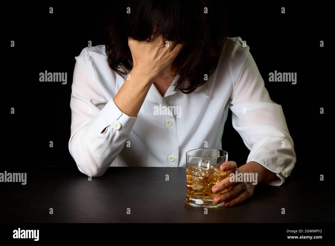 Woman Who Has Abused Alcohol With A Glass Of Scotch And Ice. Concept Of Social Problems Stock Photo