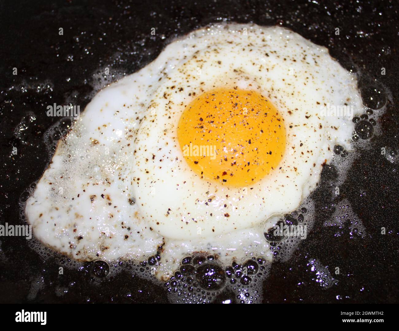 Sunny side up egg with pepper. Stock Photo