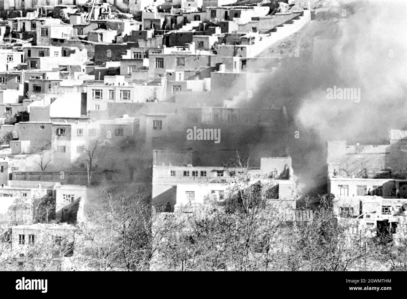KABUL, AFGHANISTAN. 4h April 1988. A rocket hits a residential neighborhood of Karte-Ye-Sakhi crowded with mud brick homes on a hillside April 16, 1988 in Kabul, Afghanistan. The rocket, fired by the Afghan mujahideen killed two young sisters playing in a courtyard. Stock Photo